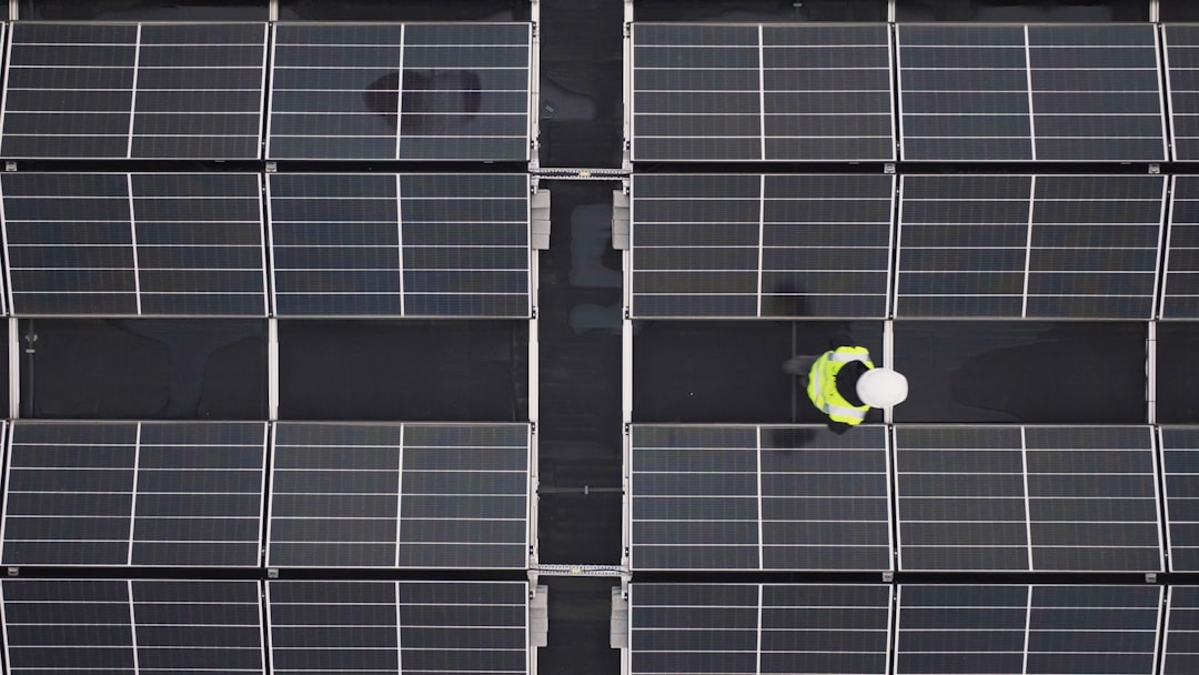 a person standing in front of a large array of solar panels